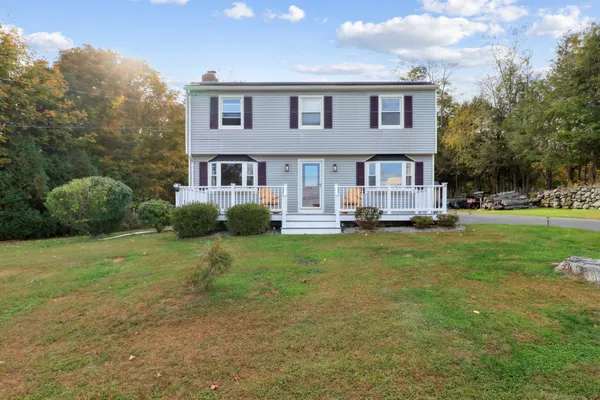 a front view of a house with a yard