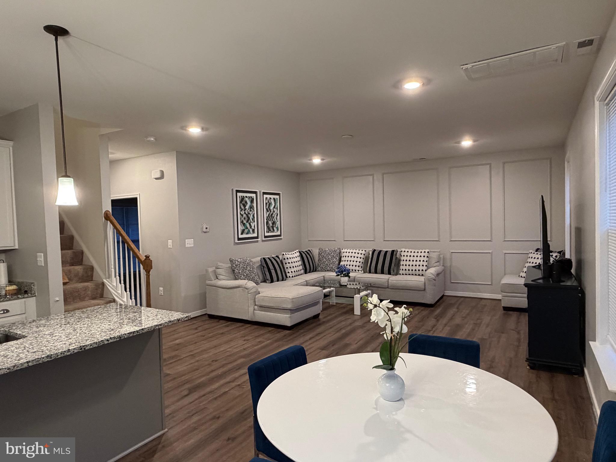 229 Bibb Street Louisa, VA 23093 - Photo 38 of 72 a living room with couches and kitchen view with wooden floor