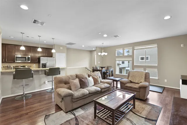 a living room with furniture and wooden floor