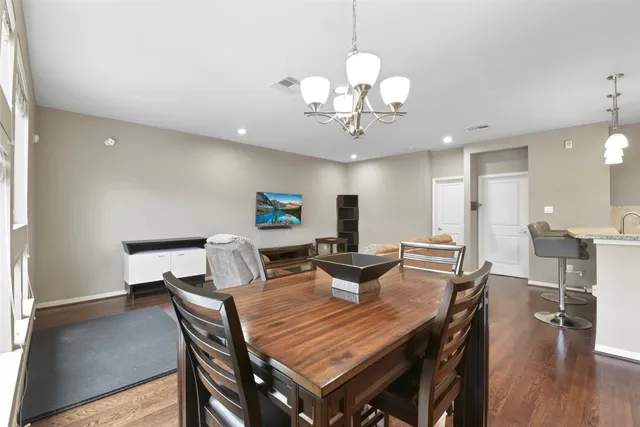 a view of a dining room with furniture wooden floor and chandelier