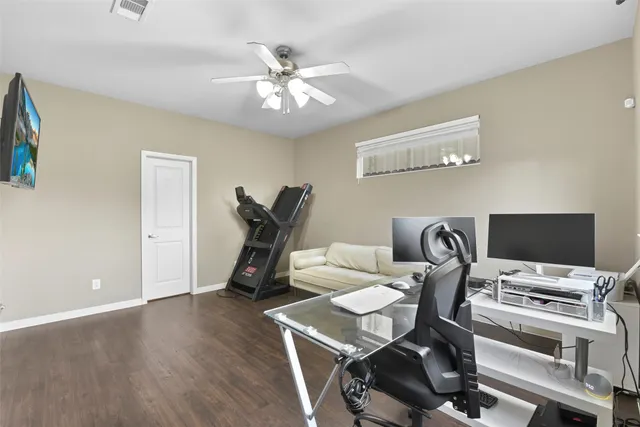 a view of a workspace with furniture and a flat screen tv