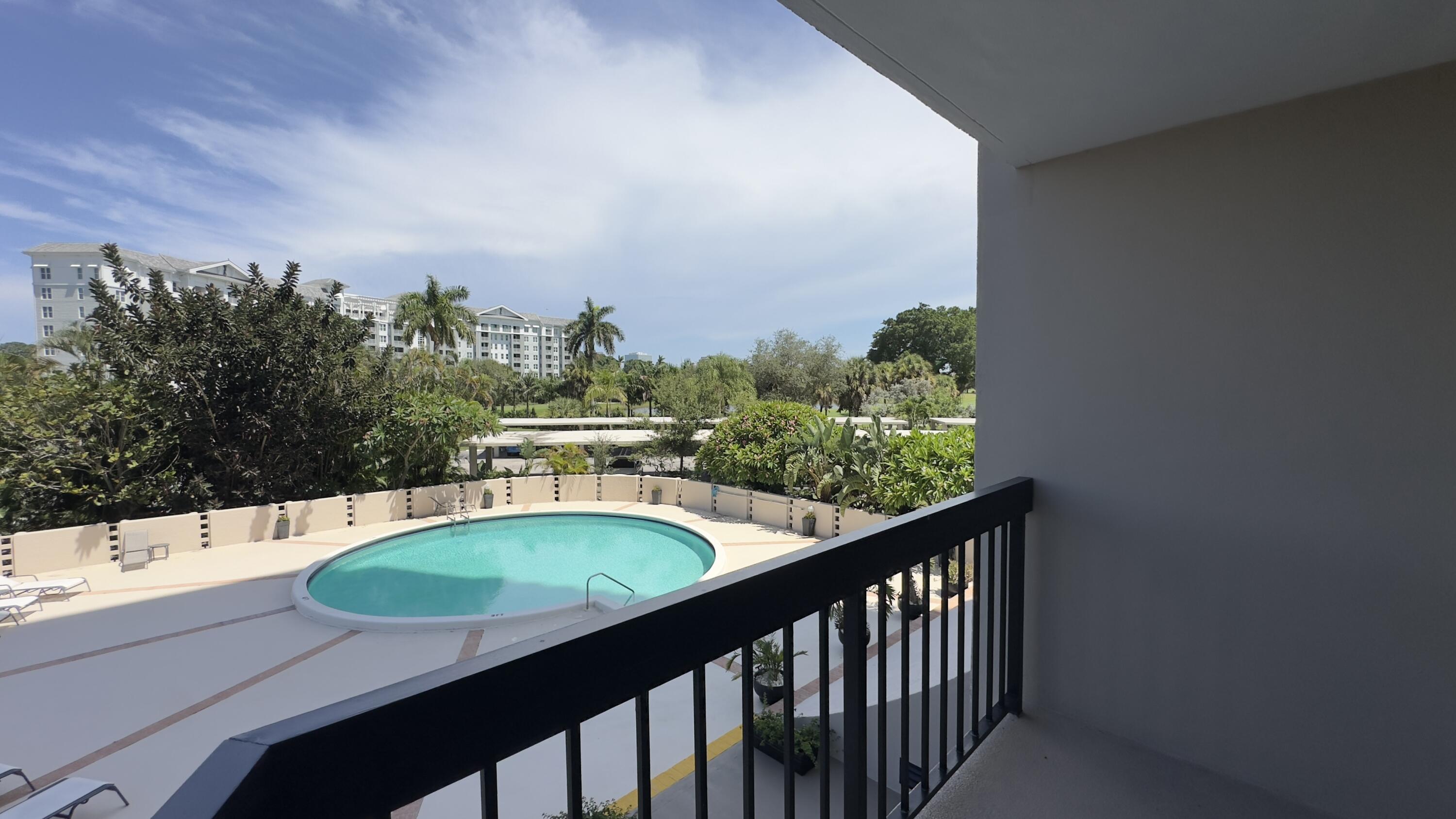 2425 Presidential Way, Unit 203 West Palm Beach, FL 33401 - Photo 20 of 35 a view of a swimming pool with a patio