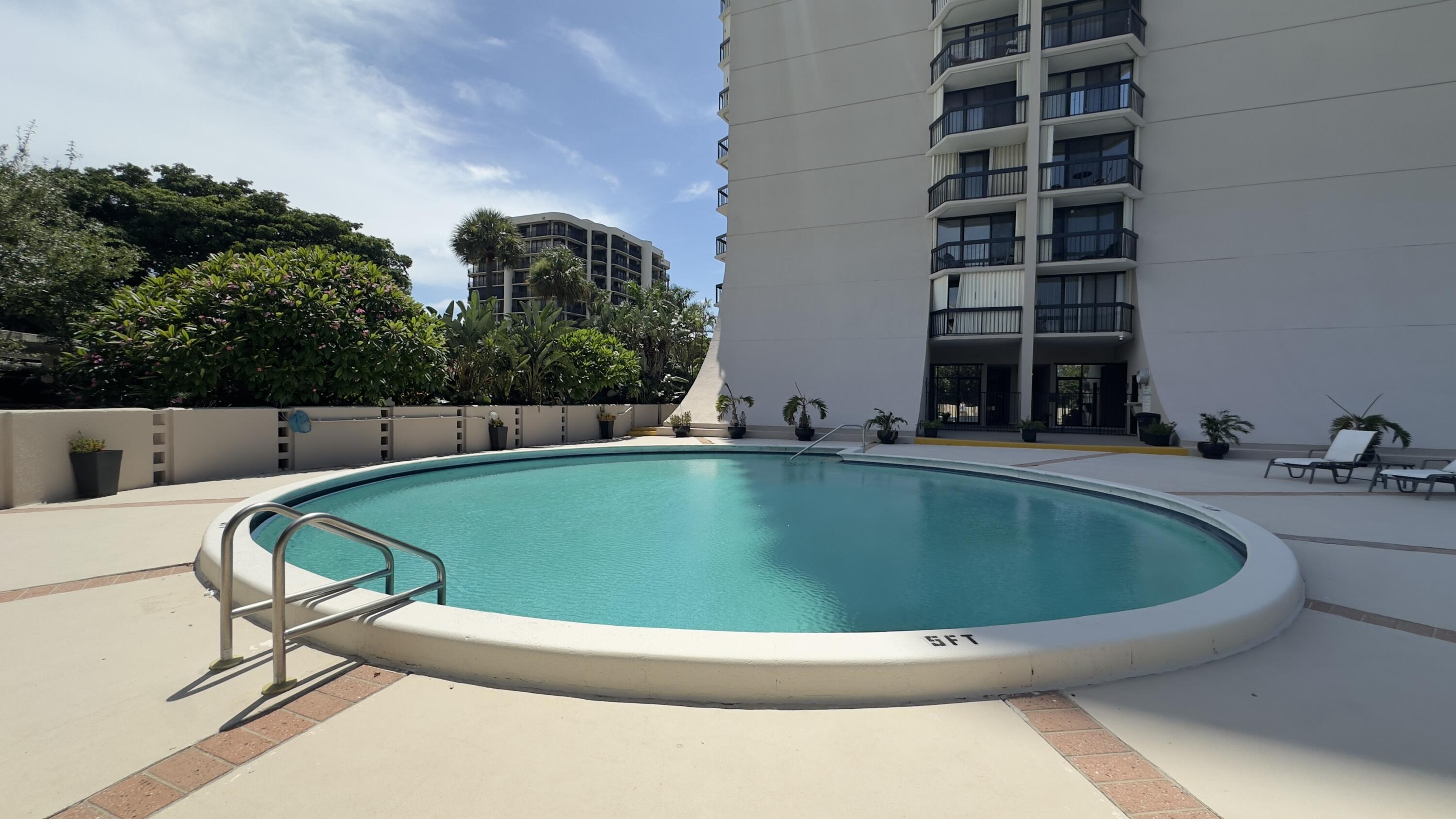 2425 Presidential Way, Unit 203 West Palm Beach, FL 33401 - Photo 25 of 35 a view of swimming pool having outdoor seating