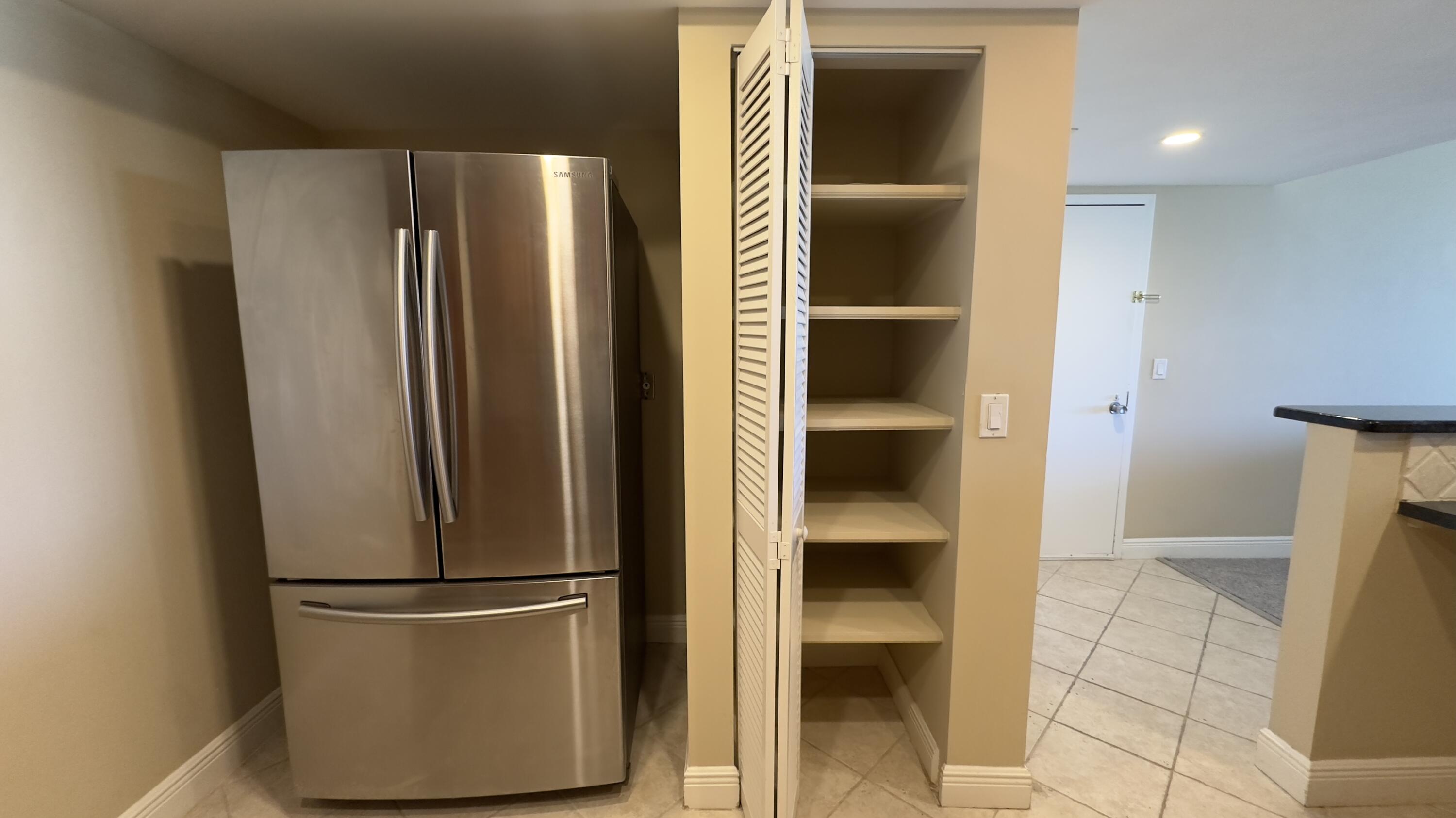 2425 Presidential Way, Unit 203 West Palm Beach, FL 33401 - Photo 6 of 35 a view of walk in closet with empty racks