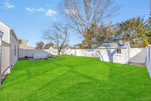 a view of yard with grass and trees
