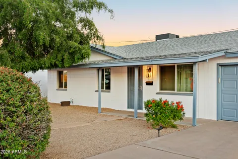 a front view of a house with a flower garden