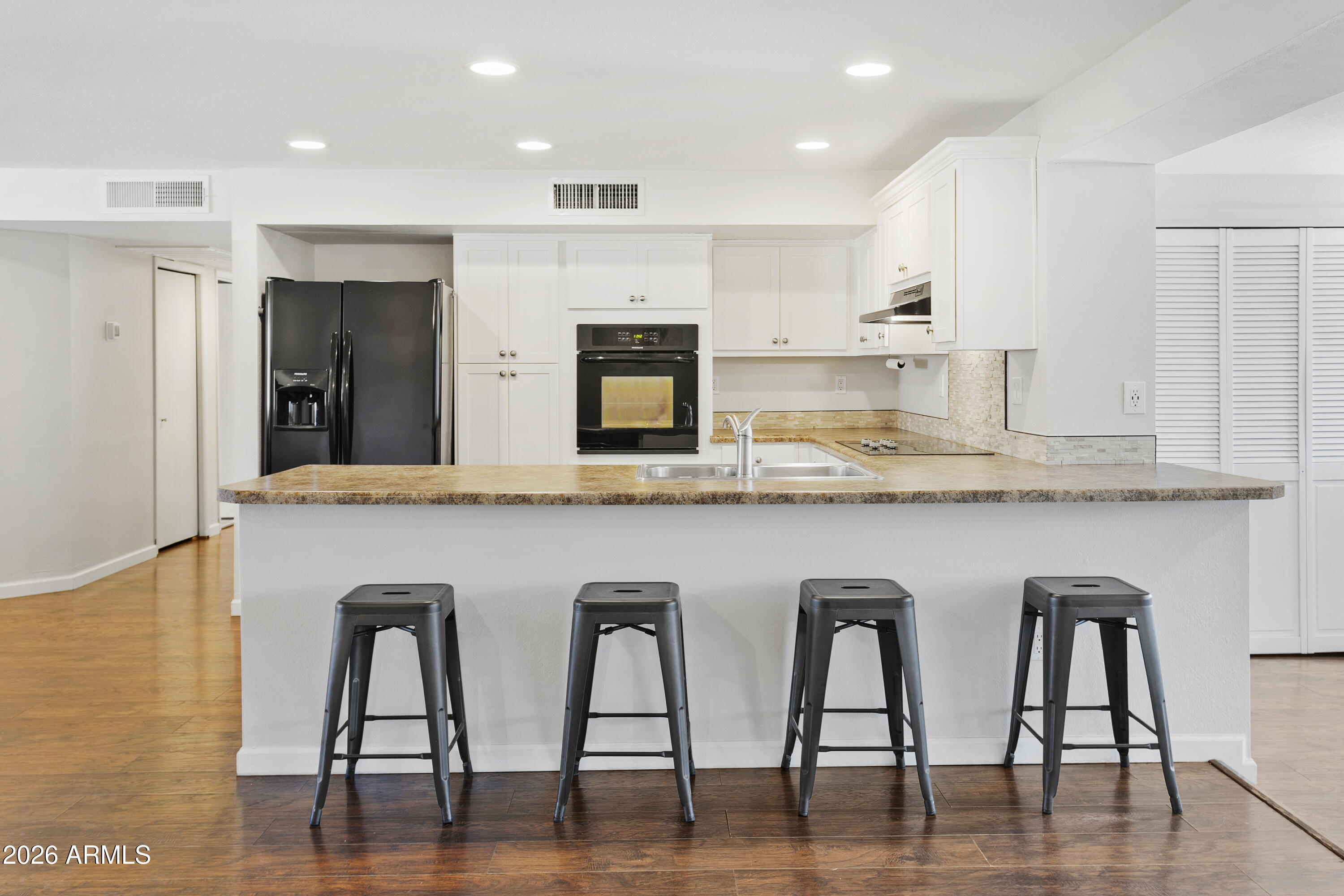 3445 East Thunderbird Road Phoenix, AZ 85032 - Photo 12 of 35 a kitchen with granite countertop white cabinets and stainless steel appliances