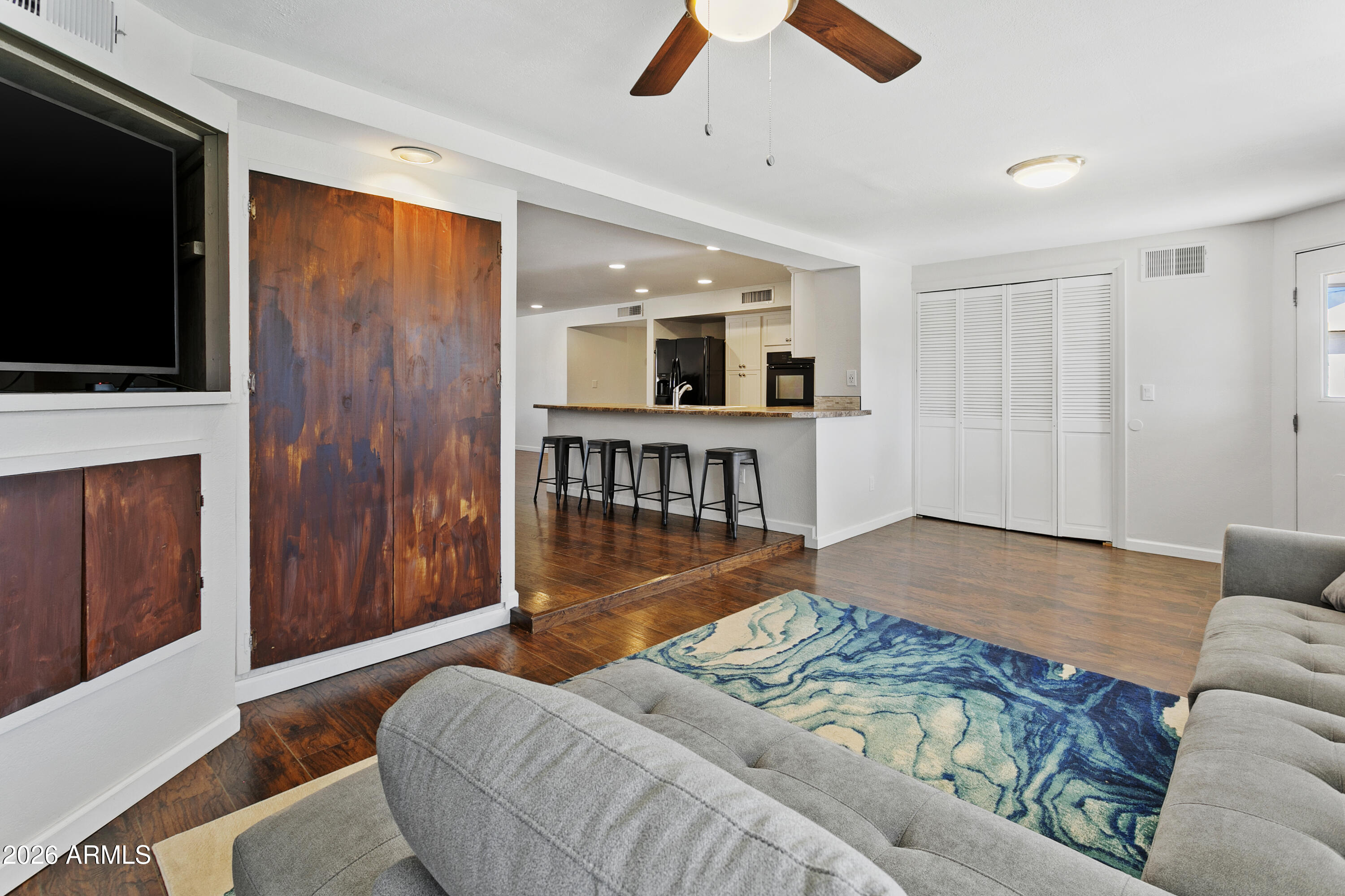 3445 East Thunderbird Road Phoenix, AZ 85032 - Photo 15 of 35 a bedroom with a bed and a flat screen tv