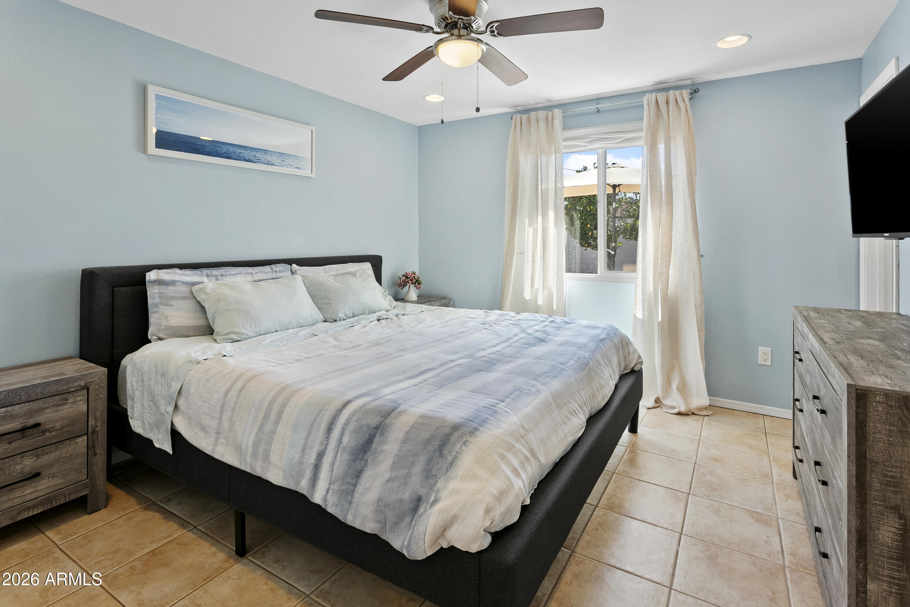 3445 East Thunderbird Road Phoenix, AZ 85032 - Photo 17 of 35 a bedroom with a bed and a flat screen tv