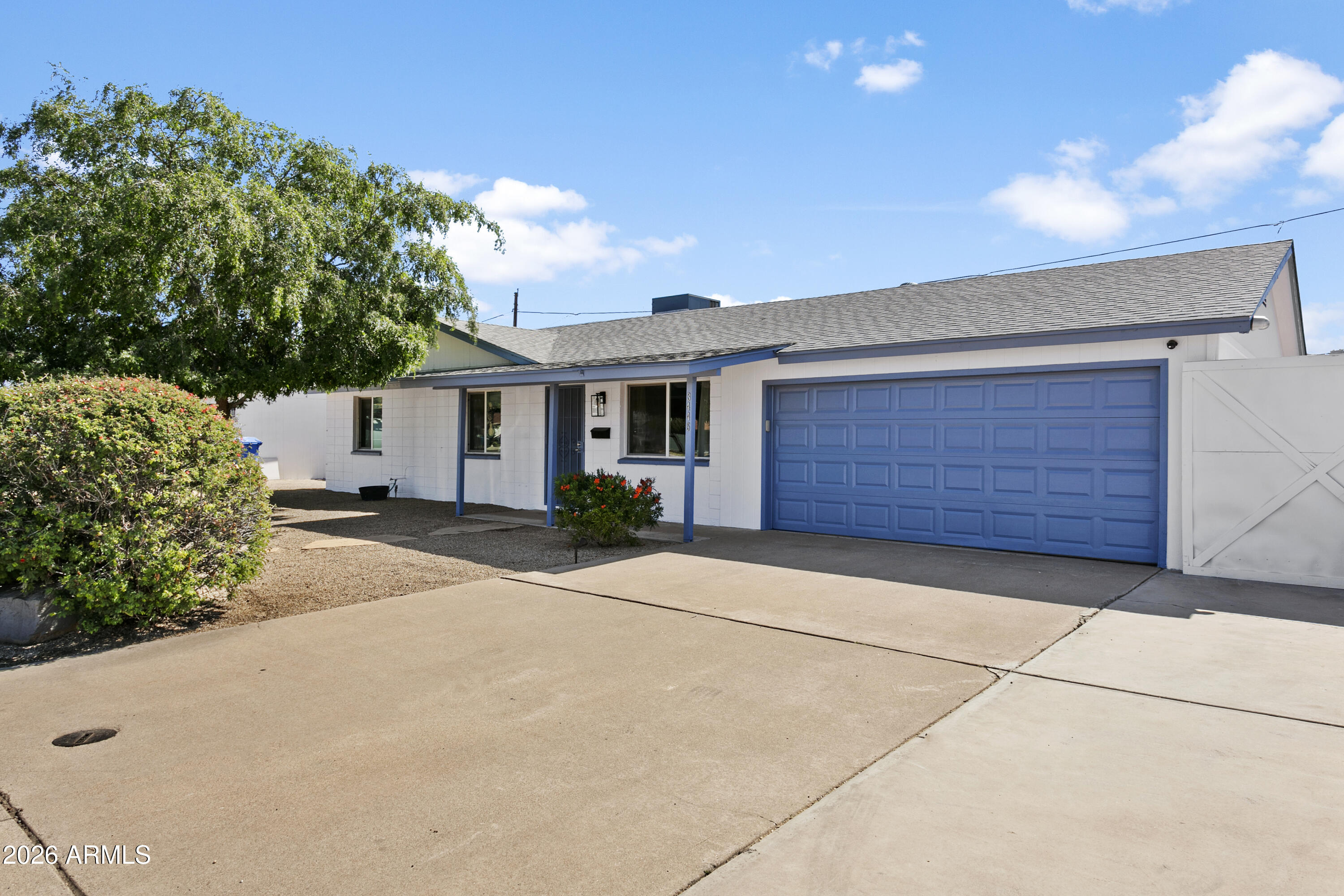 3445 East Thunderbird Road Phoenix, AZ 85032 - Photo 2 of 35 a front view of a house with a yard and garage