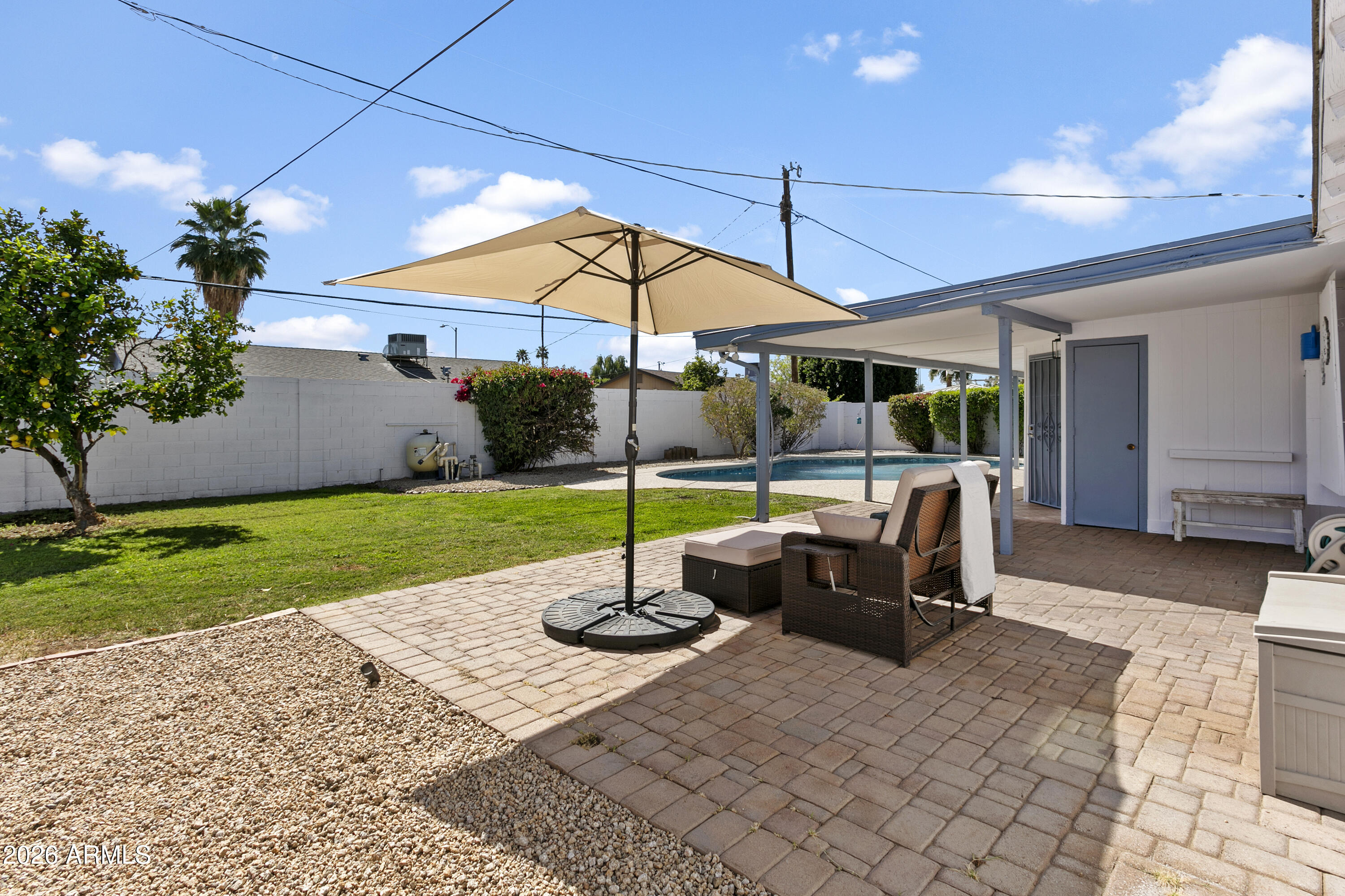 3445 East Thunderbird Road Phoenix, AZ 85032 - Photo 23 of 35 a patio with a table and chairs under an umbrella