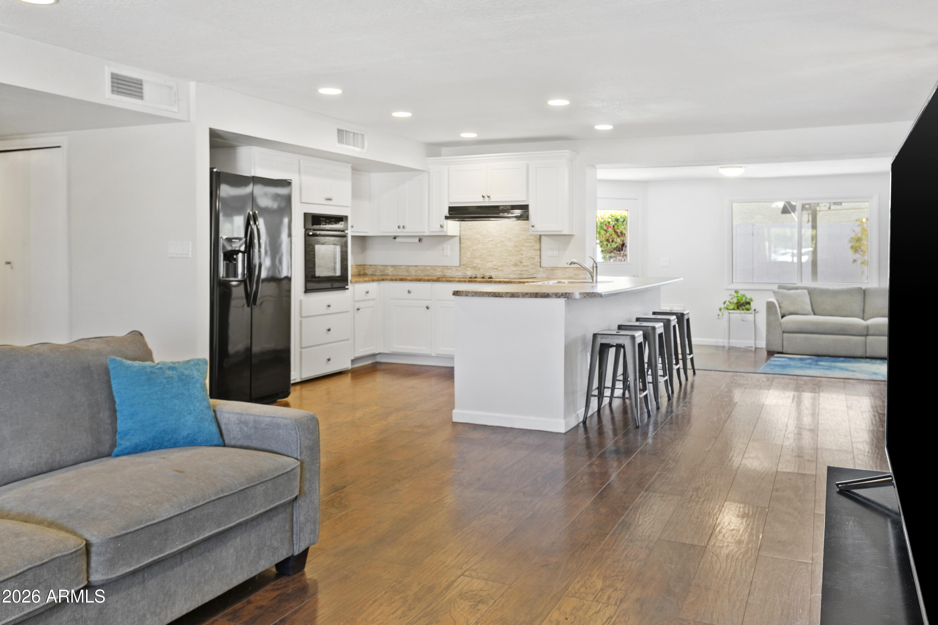 3445 East Thunderbird Road Phoenix, AZ 85032 - Photo 7 of 35 a living room with stainless steel appliances furniture and a kitchen view