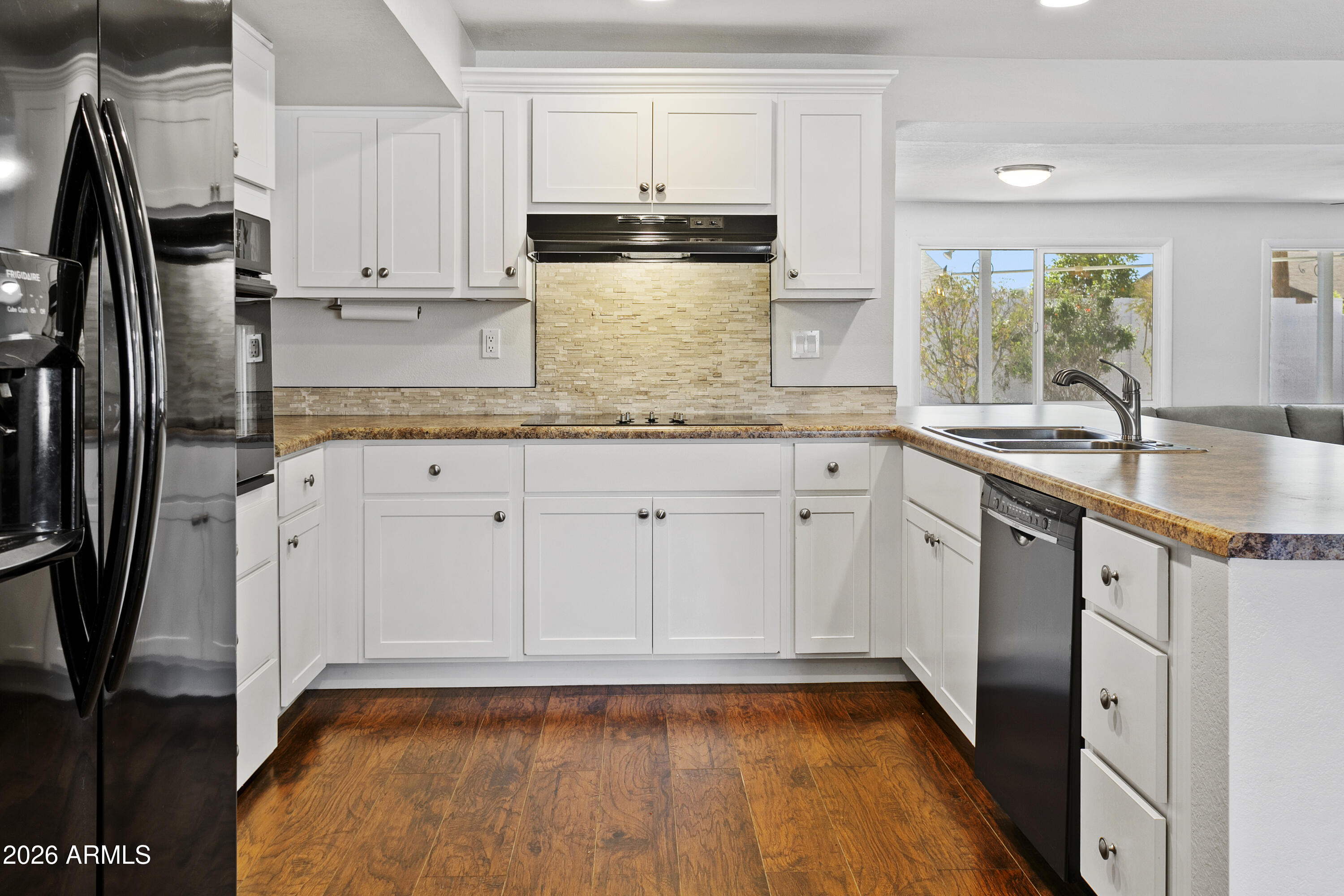 3445 East Thunderbird Road Phoenix, AZ 85032 - Photo 9 of 35 a kitchen with granite countertop a sink stainless steel appliances and white cabinets