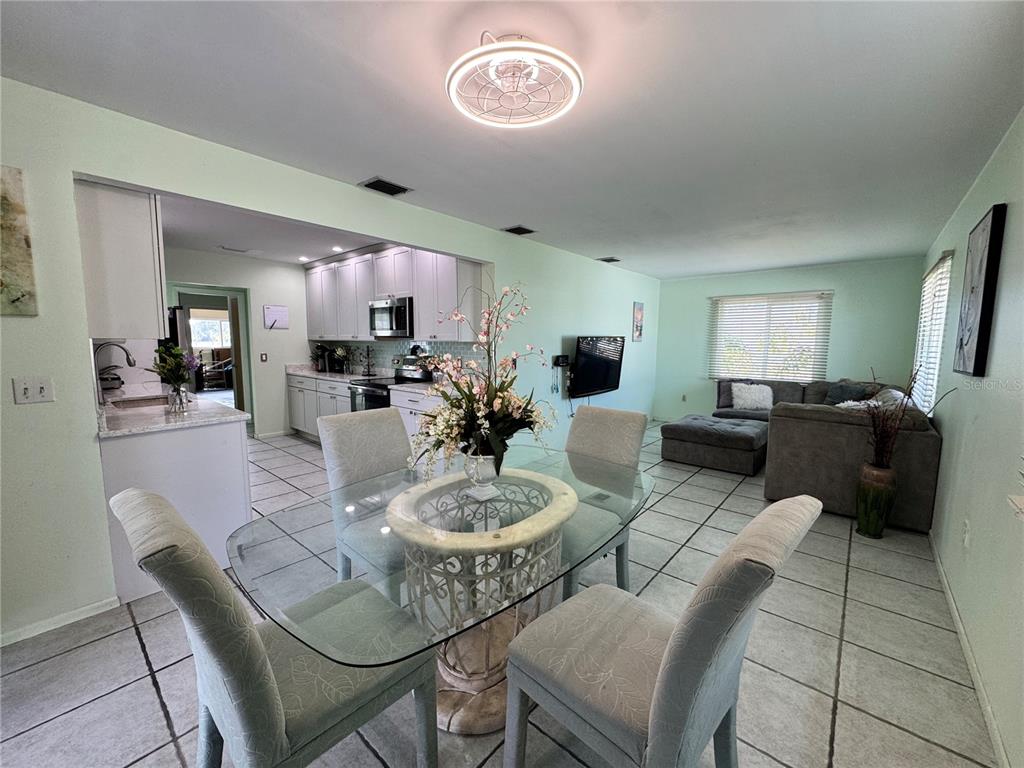 1048 Porpoise Road Venice, FL 34293 - Photo 7 of 26 a dining room with furniture and a wooden floor