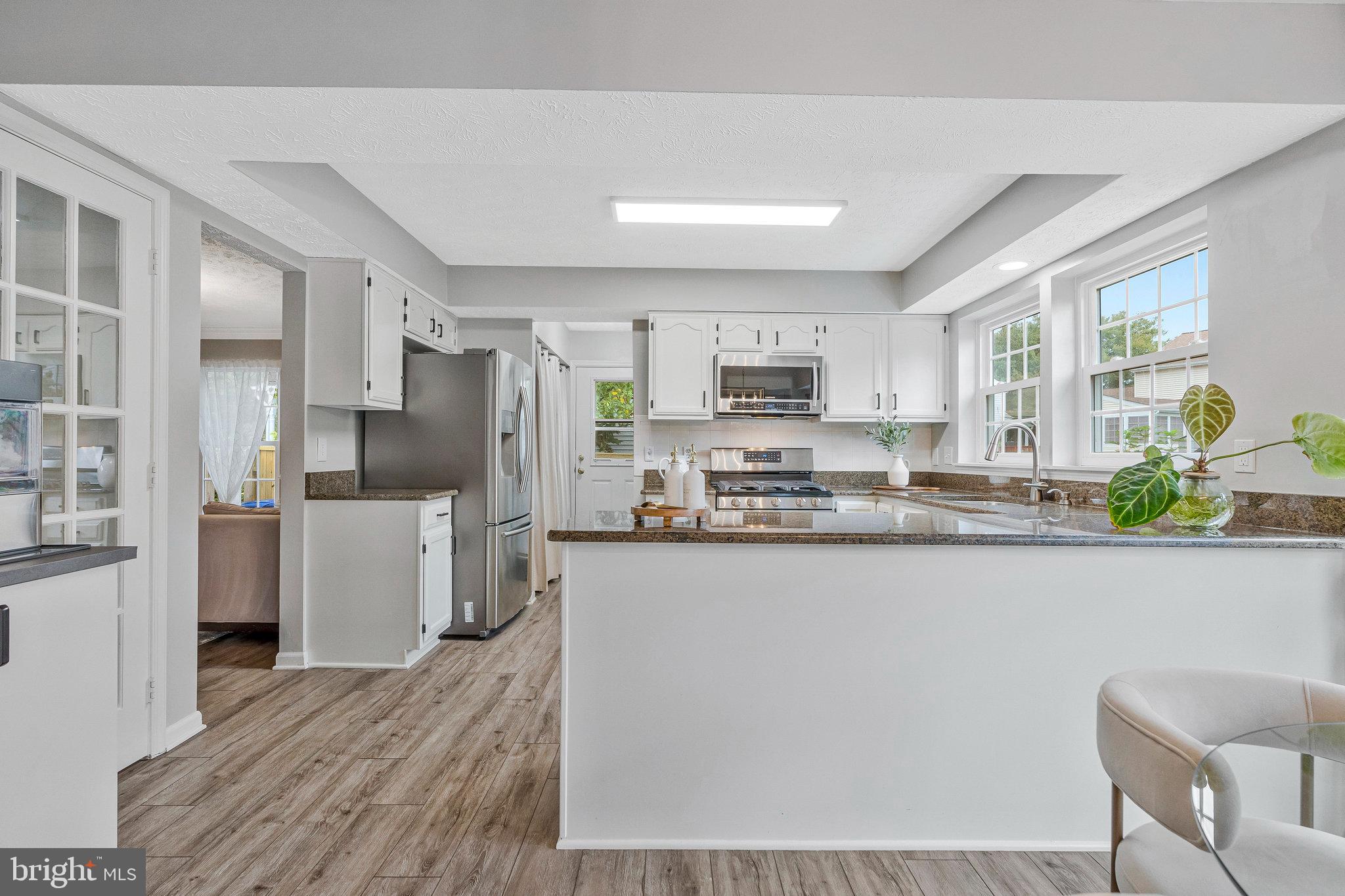 1204 James Rifle Court Northeast Leesburg, VA 20176 - Photo 12 of 51 a kitchen with stainless steel appliances granite countertop a refrigerator a stove a sink a stove a dining table and chairs
