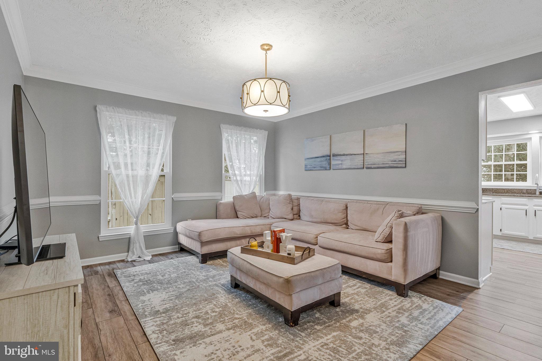 1204 James Rifle Court Northeast Leesburg, VA 20176 - Photo 20 of 51 a living room with furniture a chandelier and a window