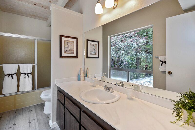 1728 Cheryl Way Aptos, CA 95003 - Photo 16 of 25 a bathroom with a granite countertop sink toilet and large mirror