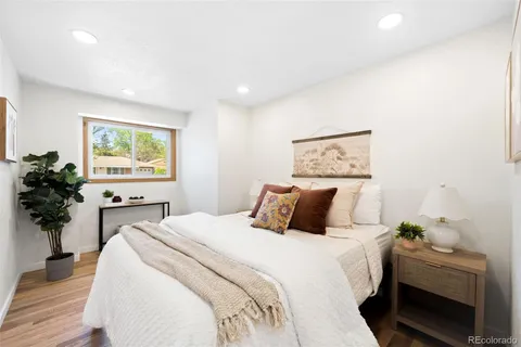 a bedroom with a bed and a potted plant