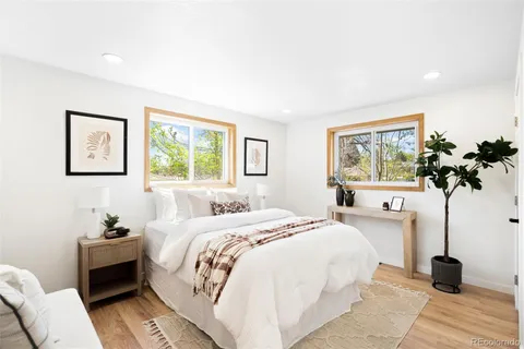 a bedroom with a bed and a potted plant
