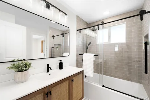 a bathroom with a shower sink and mirror