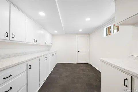 a view of a kitchen with white cabinets