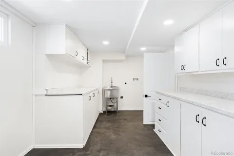 a kitchen with cabinets and a refrigerator