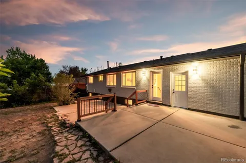 a backyard of a house with table and chairs