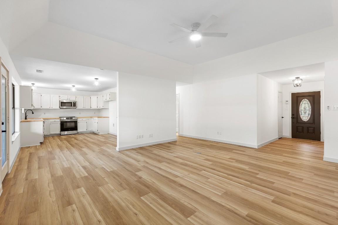 520 Hunter Ridge Road San Marcos, TX 78666 - Photo 4 of 27 a view of a kitchen with a sink and a refrigerator