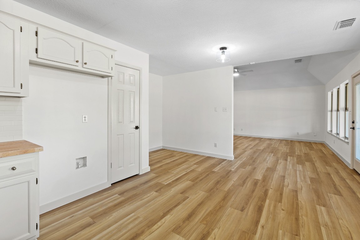 520 Hunter Ridge Road San Marcos, TX 78666 - Photo 7 of 27 a view of empty room with wooden floor and fan