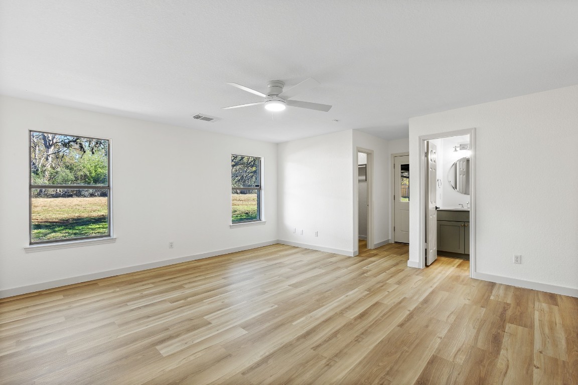 520 Hunter Ridge Road San Marcos, TX 78666 - Photo 9 of 27 a view of an empty room with window and wooden floor