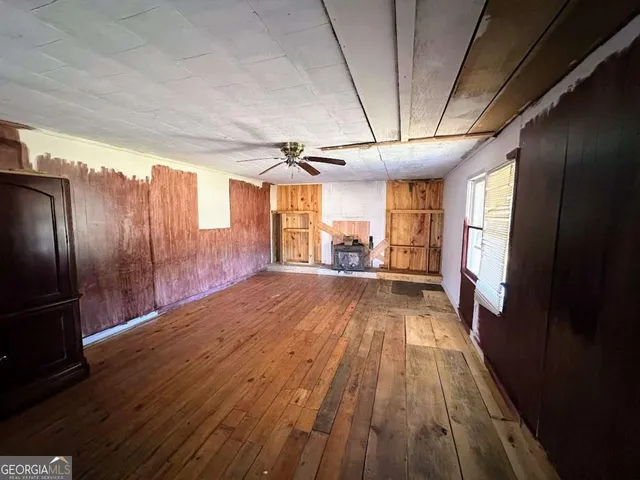 a view of a livingroom with wooden floor and furniture