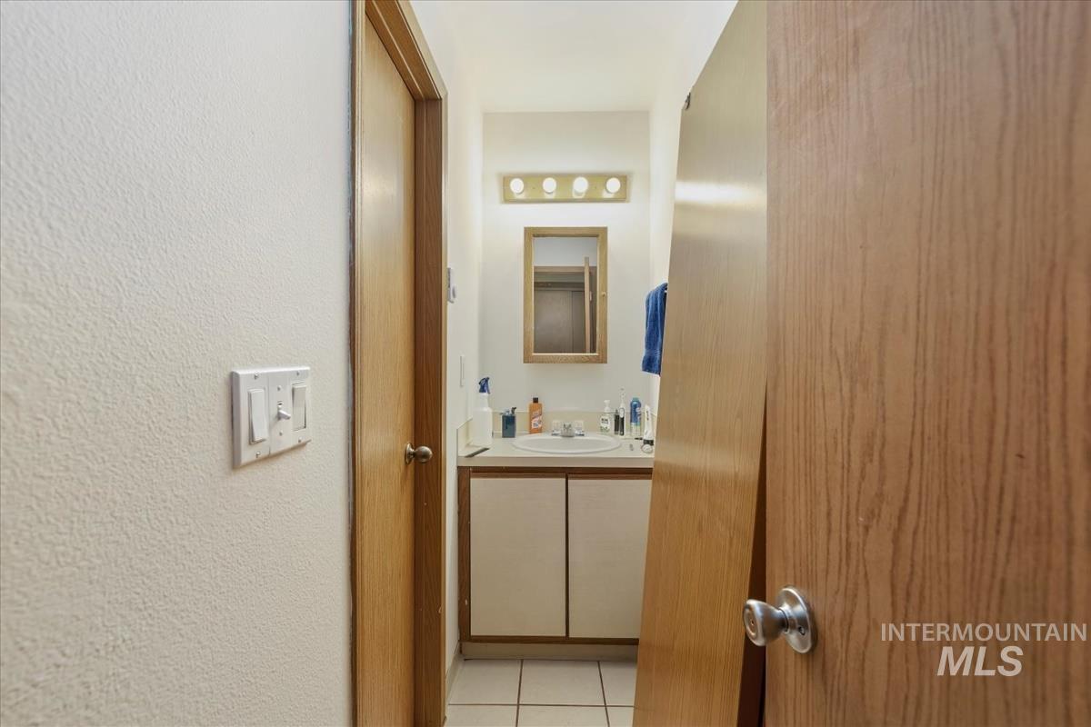 33 South Mike Street Boise, ID 83705 - Photo 22 of 50 Bathroom with light tile patterned floors, vanity, and a textured wall