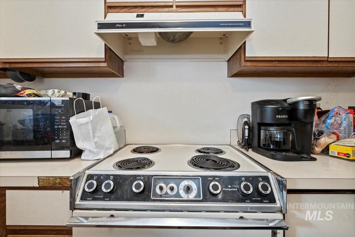 33 South Mike Street Boise, ID 83705 - Photo 32 of 50 Kitchen featuring white electric range oven, extractor fan, and light countertops