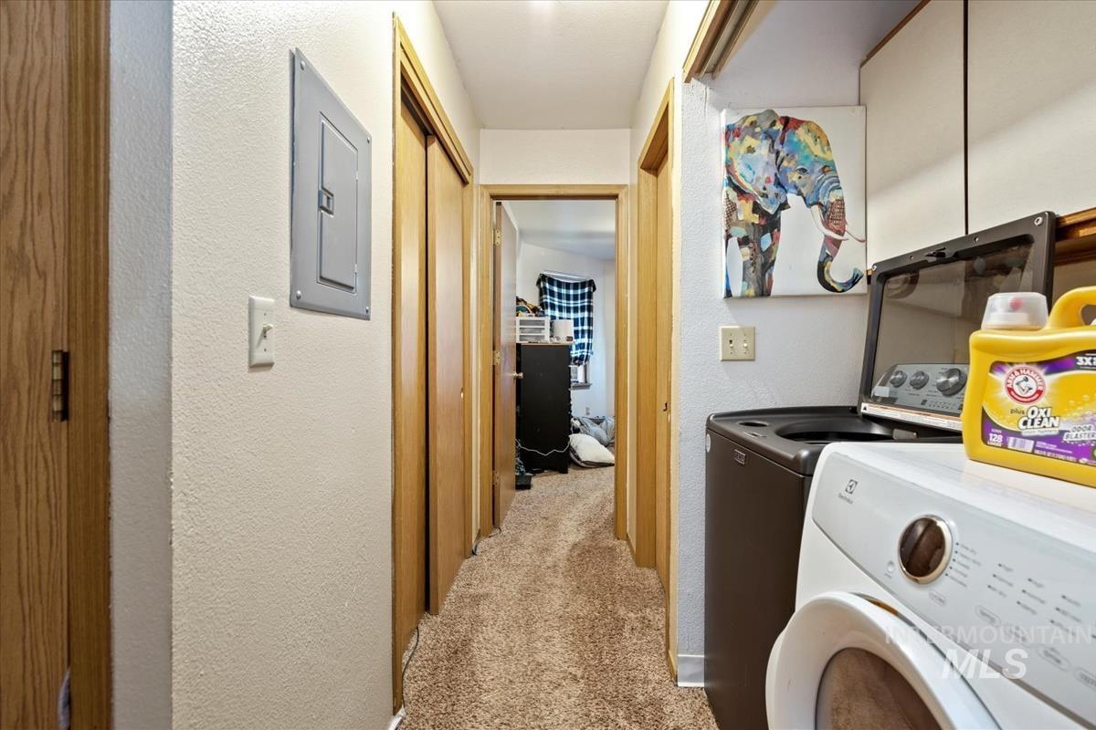 33 South Mike Street Boise, ID 83705 - Photo 36 of 50 Laundry room with a textured wall, light carpet, electric panel, and independent washer and dryer
