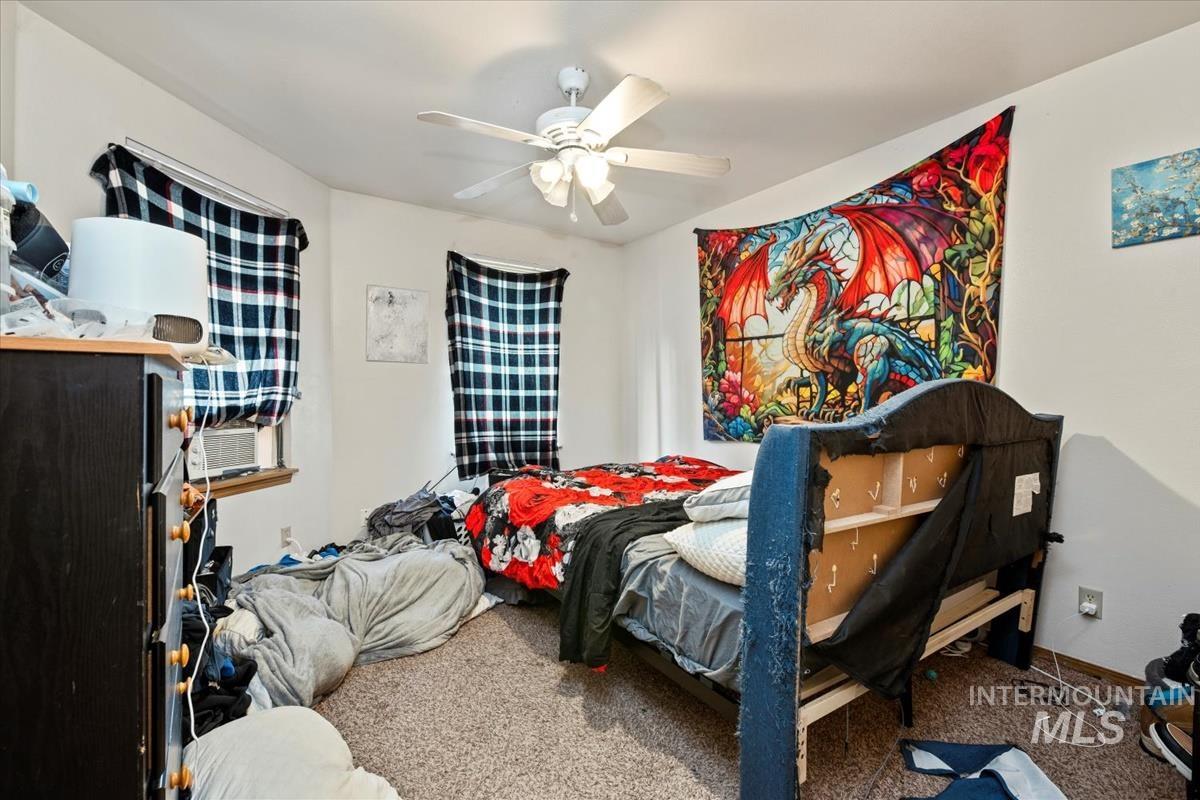 33 South Mike Street Boise, ID 83705 - Photo 38 of 50 Carpeted bedroom with a ceiling fan and cooling unit