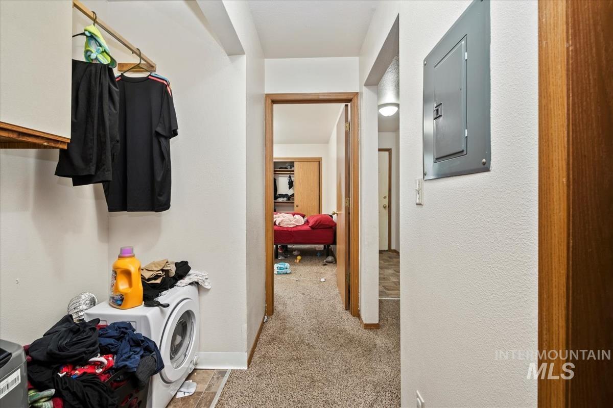 33 South Mike Street Boise, ID 83705 - Photo 45 of 50 Hallway with electric panel, light colored carpet, and washer / clothes dryer