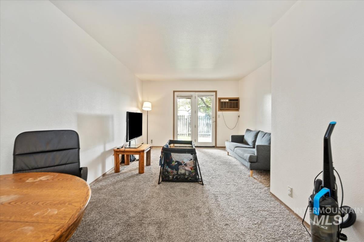 33 South Mike Street Boise, ID 83705 - Photo 46 of 50 Living area featuring carpet and a wall mounted air conditioner
