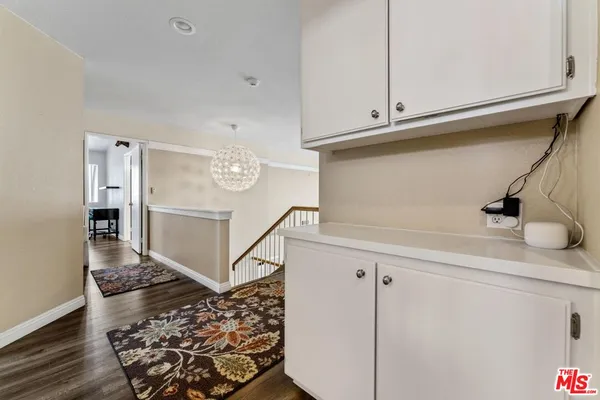 a view of kitchen with cabinets and wooden floor