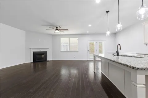 a view of a kitchen with a sink and wooden floor