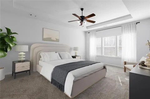 a bedroom with a bed a couch and a window