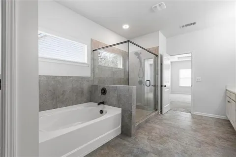 a bathroom with a bathtub and a shower
