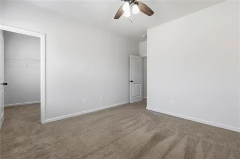 an empty room with a empty space and chandelier fan