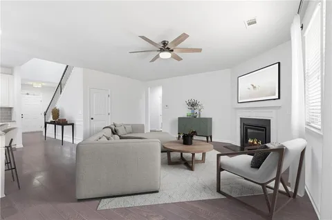 a living room with furniture a fireplace and a flat screen tv