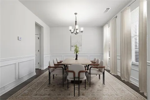 a view of a a dining room with furniture window and wooden floor