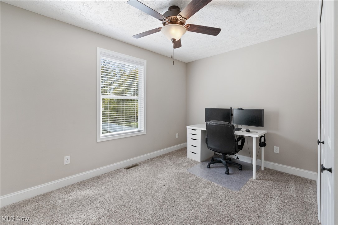 3124 Huntcliffe Road Northeast Canton, OH 44721 - Photo 19 of 35 Carpeted office space with ceiling fan and a textured ceiling
