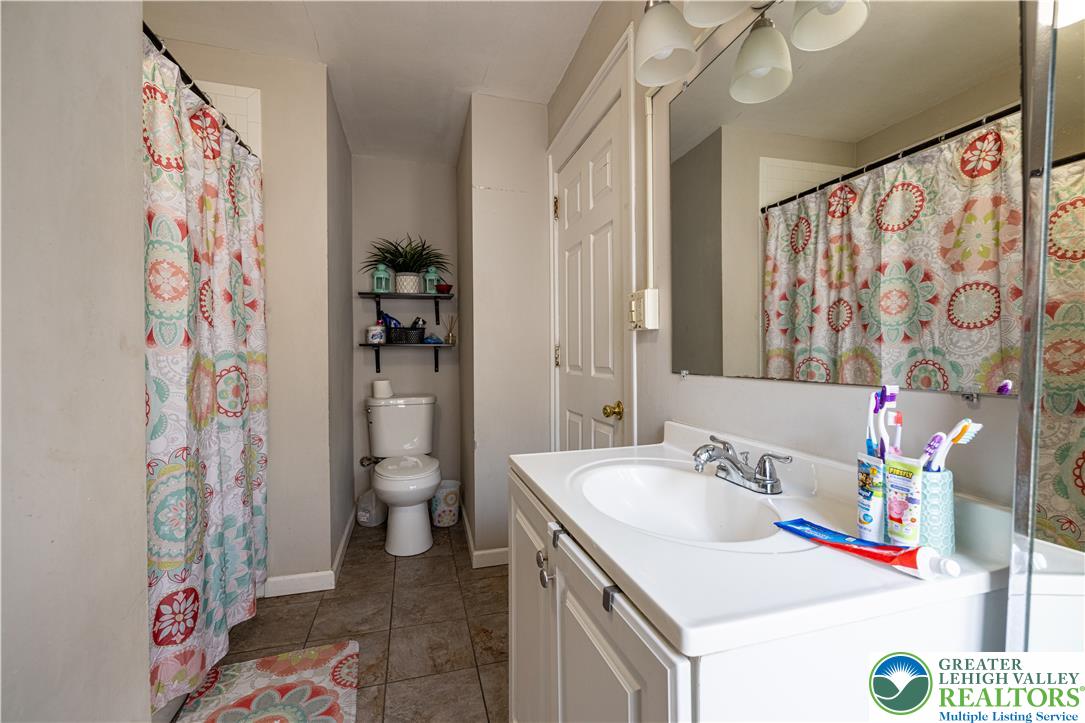 118 South 3rd Street Bangor, PA 18013 - Photo 20 of 33 This bright bathroom features a vanity, toilet, and a convenient shower with ample space.