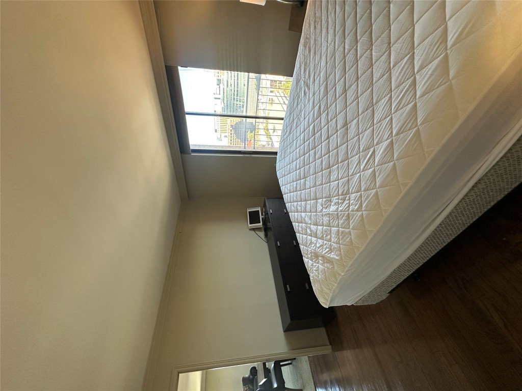1122 Colorado Street, Unit 1902 Austin, TX 78701 - Photo 12 of 15 a bed sitting in a bedroom next to a window
