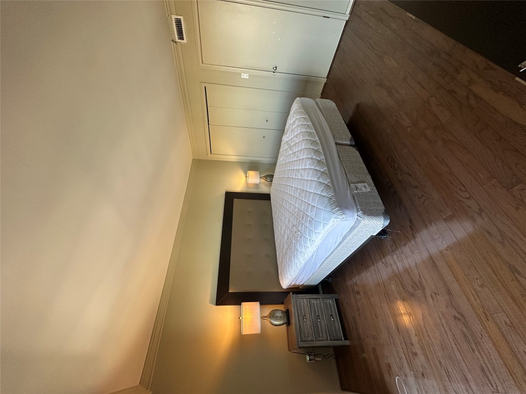 1122 Colorado Street, Unit 1902 Austin, TX 78701 - Photo 13 of 15 a bedroom with a bed and a table in it