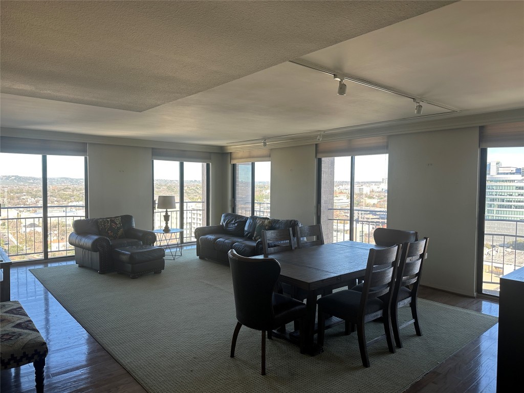 1122 Colorado Street, Unit 1902 Austin, TX 78701 - Photo 6 of 15 a view of a dining room with furniture a couch and wooden floor
