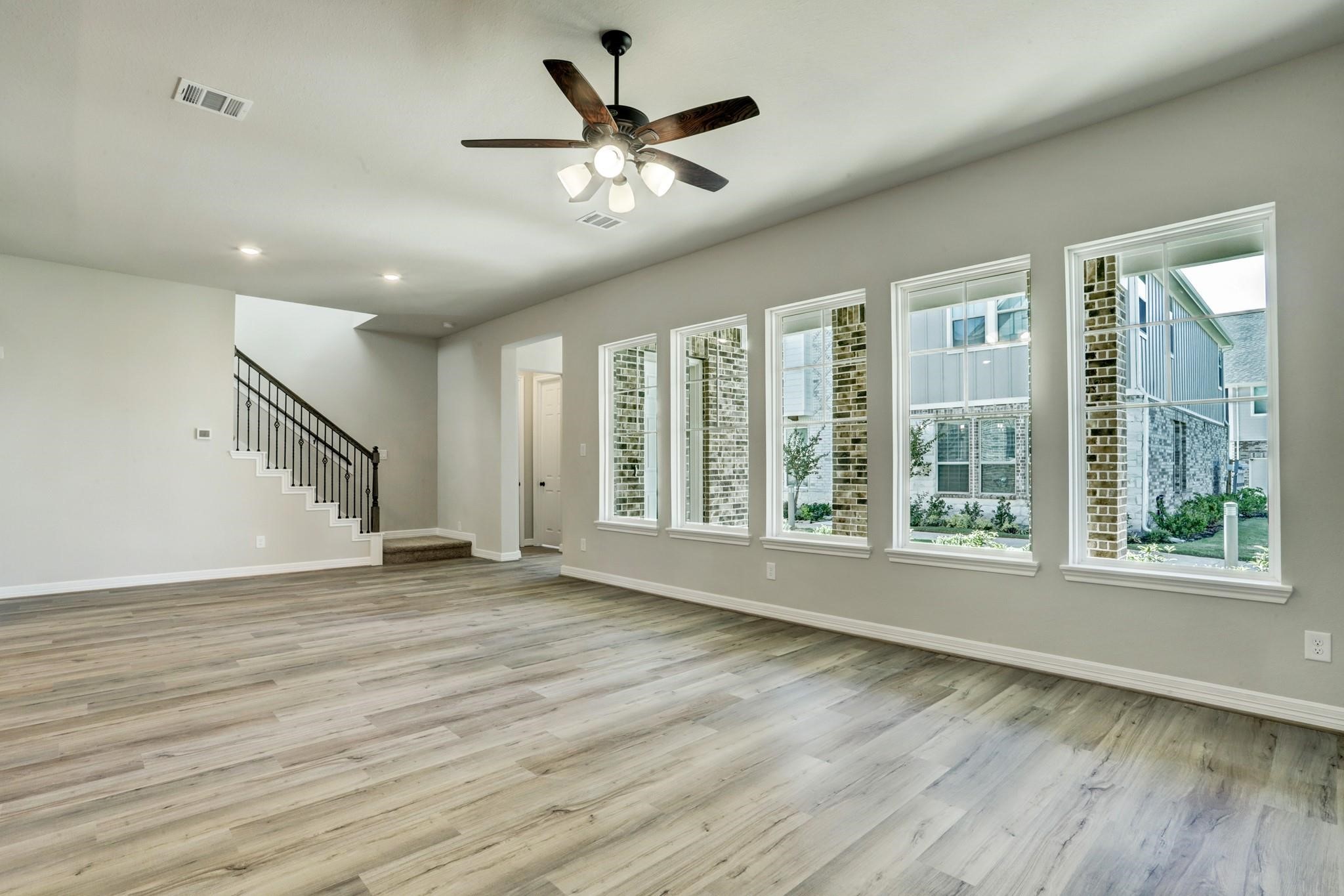 9522 Caddo Ridge Lane Cypress, TX 77433 - Photo 11 of 38 a view of an empty room with wooden floor and a window